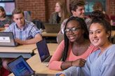 Students smiling in class. Links to Closely Held Business Stock Students smiling in class. Links to Closely Held Business Stock